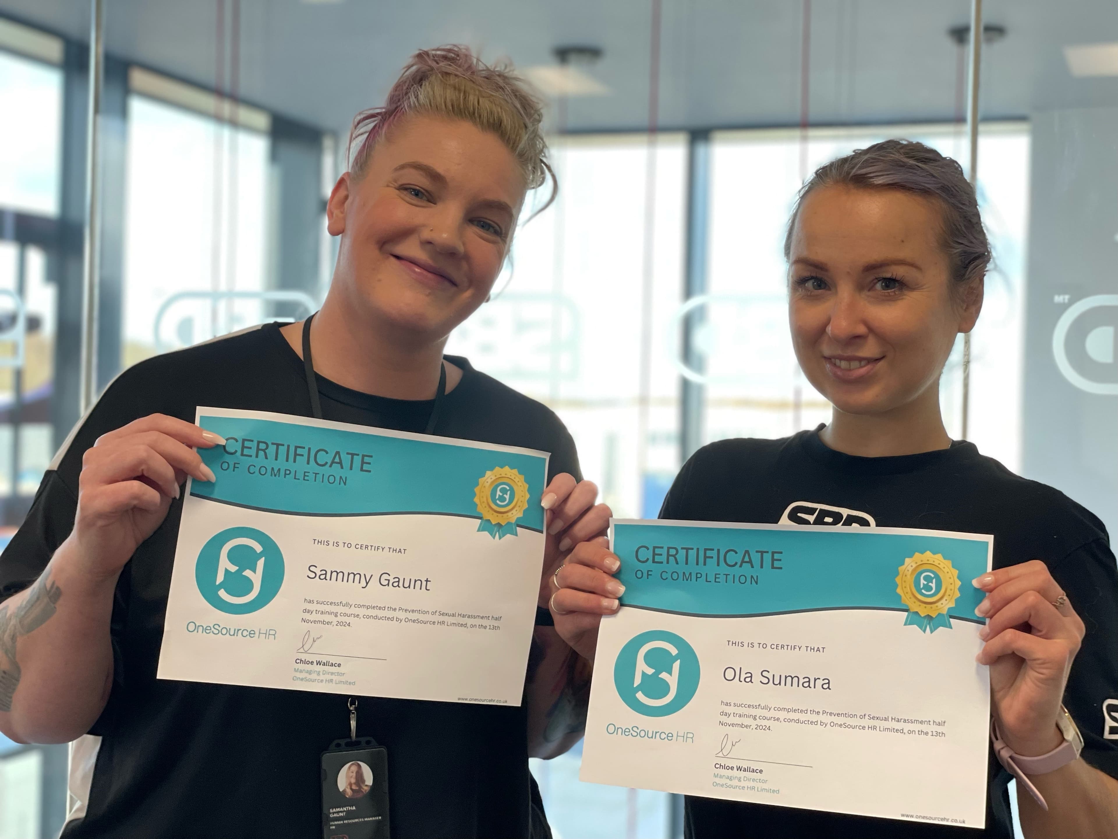 Two delegates with their OneSource HR training completion certificates